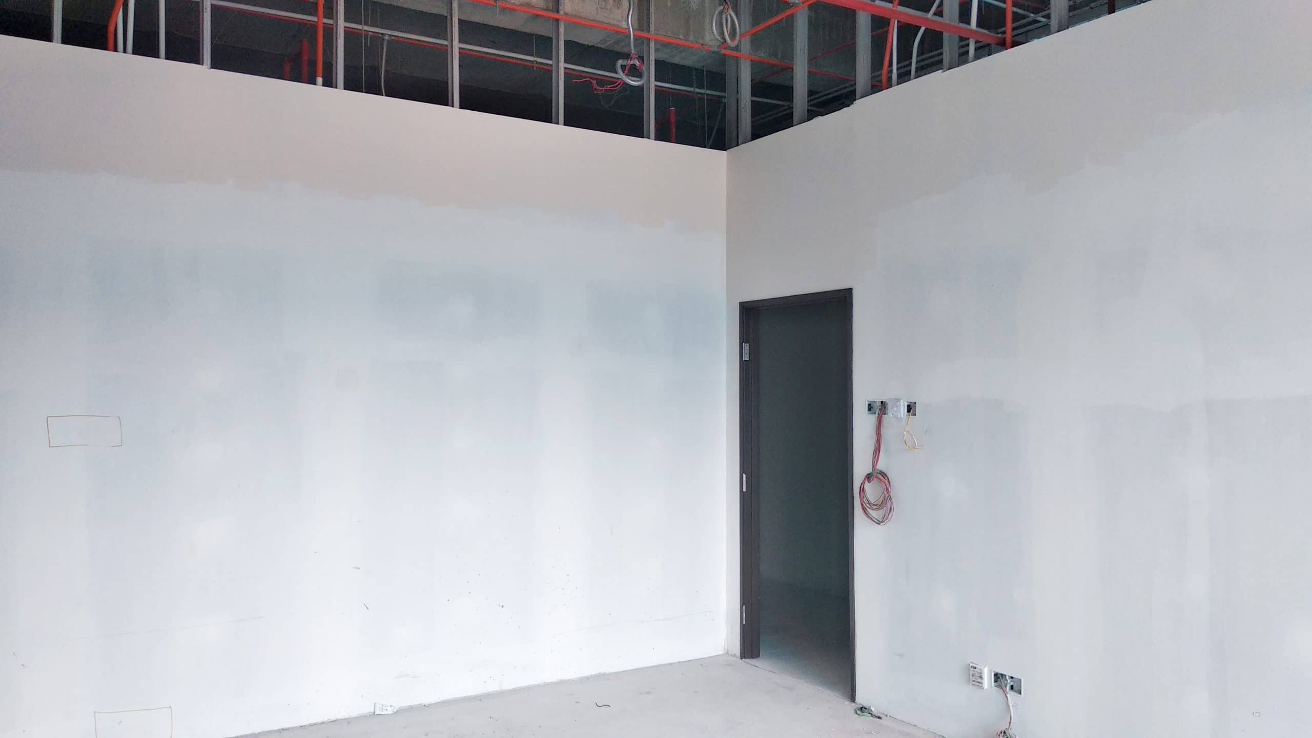 Drywall installation work in progress by construction workers at the construction site. It is the easiest and cheapest way to do partition for an interior wall.